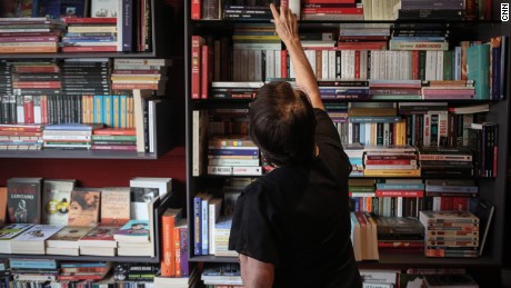 Nuran, a bookstore owner, poses for a photo in her shop, in Istanbul.