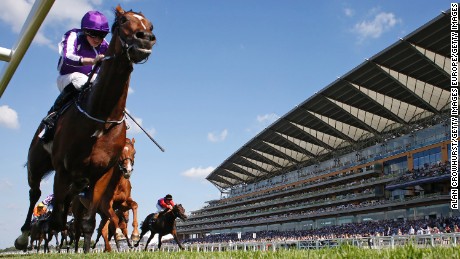 Ryan Moore riding Highland Reel races towards the line in The King George VI And Queen Elizabeth Stakes at Ascot Racecourse.