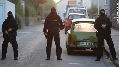 Special police forces secure a street near the house occupied by a Syrian man who detonated a  bomb outside a music festival in Ansbach, Sunday.