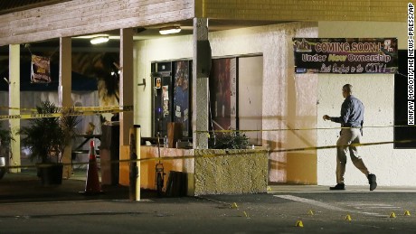 An investigator walks near the scene of a fatal shooting at Club Blu nightclub in Fort Myers, Florida on Monday, July 25.