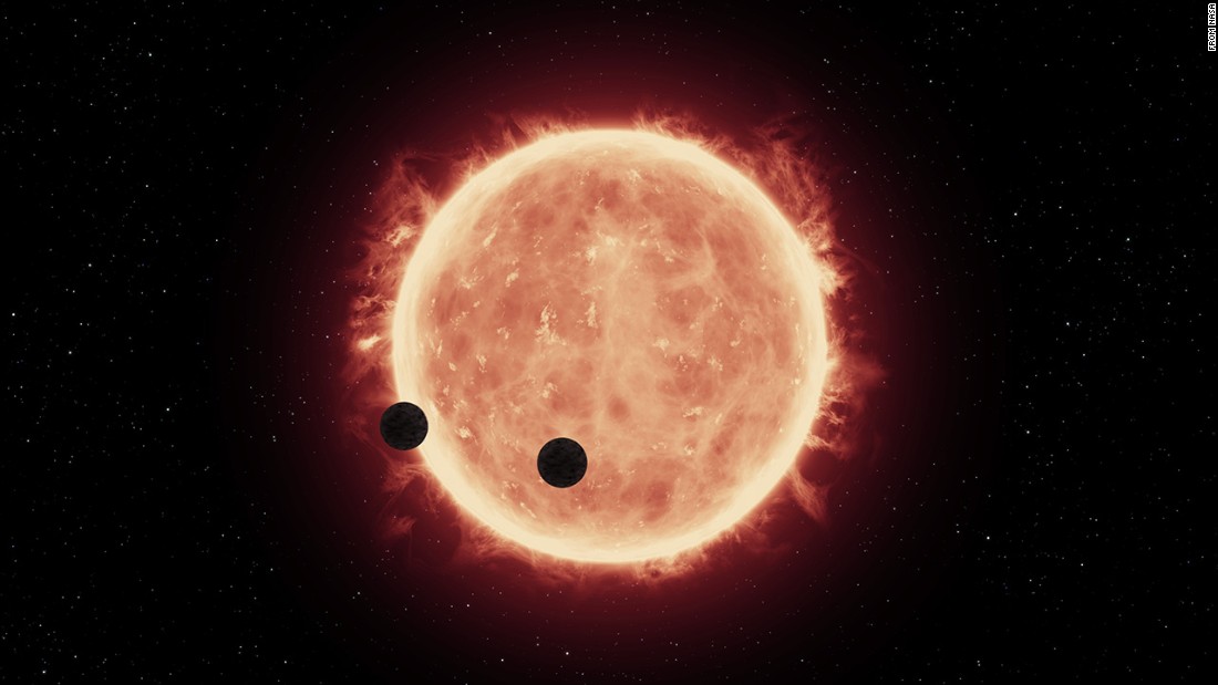 An artist&#39;s rendering shows Earth-sized exoplanets TRAPPIST-1b and 1c in a rare double transit event as they pass in front of their ultracool red dwarf star, which allowed Hubble to take a peek at at their atmospheres. 