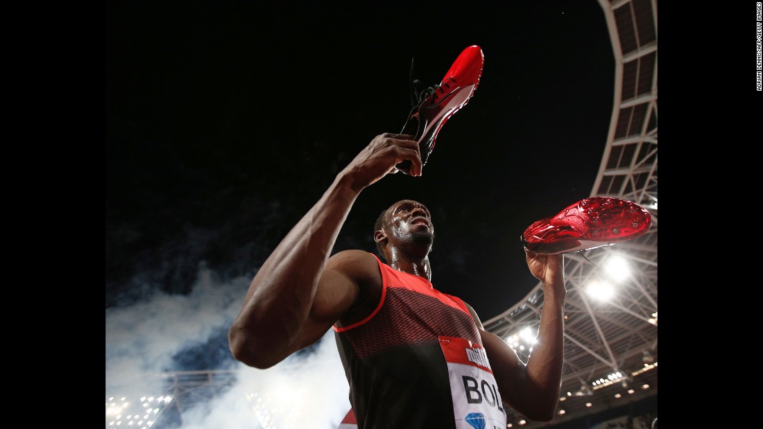 Jamaica&#39;s Usain Bolt holds out his spikes as he interacts with spectators after winning the men&#39;s 200m at the IAAF Diamond League Anniversary Games athletics meeting at the Queen Elizabeth Olympic Park stadium in Stratford, east London on July 22, 2016.