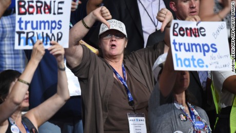 A Bernie Sanders supporter gestures during Day 1 of the Democratic National Convention at the Wells Fargo Center in Philadelphia, Pennsylvania, July 25, 2016. / AFP / Robyn BECK        (Photo credit should read ROBYN BECK/AFP/Getty Images)