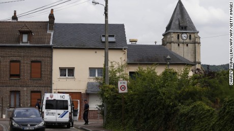 Police officers stand on guard behind the church of Saint-Etienne-du-Rouvray on July 26, 2016, following an attack by two knife-wielding men.
The Islamic State group said on July 26 that the two assailants who stormed a church in France and killed an elderly priest were its &quot;soldiers,&quot;. They stormed the church during morning mass, taking the five people inside hostage and slitting the throat of its priest Jacques Hemel, who was in his eighties. The attackers were killed by police after they emerged from the church when it was surrounded by France&#39;s anti-gang brigade, the BRI, which specialises in kidnappings.
 / AFP PHOTO / CHARLY TRIBALLEAUCHARLY TRIBALLEAU/AFP/Getty Images