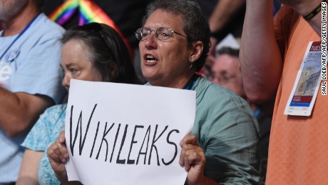 A woman holds up a sign referencing Wikileaks during Day 2 of the Democratic National Convention at the Wells Fargo Center in Philadelphia, Pennsylvania, July 26, 2016. / AFP / SAUL LOEB        (Photo credit should read SAUL LOEB/AFP/Getty Images)