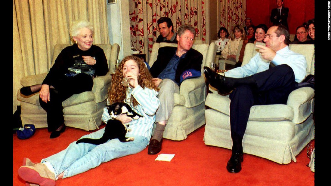 Clinton chats with former New York Governor Governor Mario Cuomo, while daughter Chelsea Clinton cuddles Socks at the White House in 1993. 