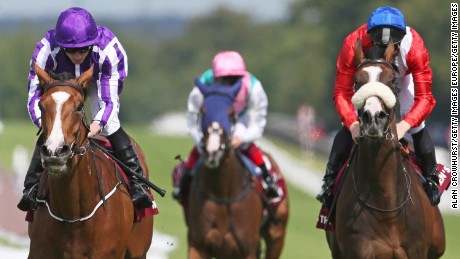 Ryan Moore rides Minding (L) to victory at the Nassau Stakes at Goodwood.
