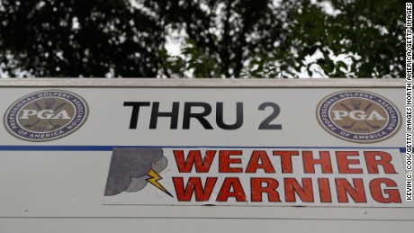 A weather warning sign is displayed on a leaderboard during a delay on day three of the 2016 PGA Championship.