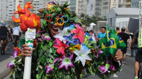 A man disguised as Batman holds a fake Olympic torch reading &quot;Shame&quot; during a protest against suspended president Dilma Rousseff and former president Luiz Inacio Lula Da Silva, at Copacabana beach in Rio de Janeiro, Brazil, on July 31, 2016.
Protesters took to the streets of Brazil on Sunday to demand the final leaving of suspended President Dilma Rousseff or to defend her continuance, just five days before the start of the Rio 2016 Olympic Games. / AFP / TASSO MARCELO        (Photo credit should read TASSO MARCELO/AFP/Getty Images)