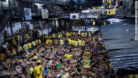 Inmates sleep on the ground of an open basketball court inside the Quezon City jail at night in Manila in this picture taken on July 21, 2016.
There are 3,800 inmates at the jail, which was built six decades ago to house 800, and they engage in a relentless contest for space. Men take turns to sleep on the cracked cement floor of an open-air basketball court, the steps of staircases, underneath beds and hammocks made out of old blankets.  / AFP / NOEL CELIS / TO GO WITH AFP STORY: Philippines-politics-crime-jails, FOCUS by Ayee Macaraig        (Photo credit should read NOEL CELIS/AFP/Getty Images)