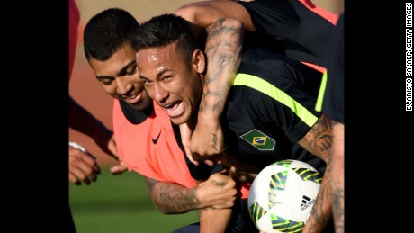 Brazilian footballers Neymar (R) and Gabriel Jesus joke during a training session.