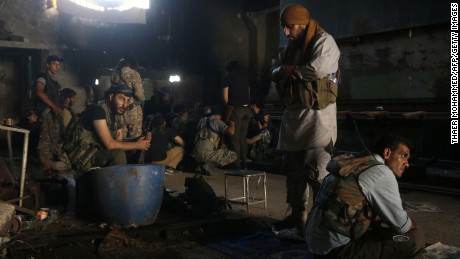 Fighters from the opposition forces pray and rest in a building on August 2, 2016 as they battle in the Ramouse industrial neighbourhood on the southern outskirts of Aleppo in a bid to break the government seige on the northern Syrian city.
The Syrian regime&#39;s key ally Russia launched heavy air strikes overnight on the outskirts of divided Aleppo city, slowing a &quot;last-chance&quot; assault by rebels seeking to break a government siege. / AFP PHOTO / THAER MOHAMMEDTHAER MOHAMMED/AFP/Getty Images