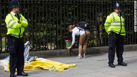A woman lays flowers at the scene of the knife attack in London&#39;s Russell Square  on Thursday.