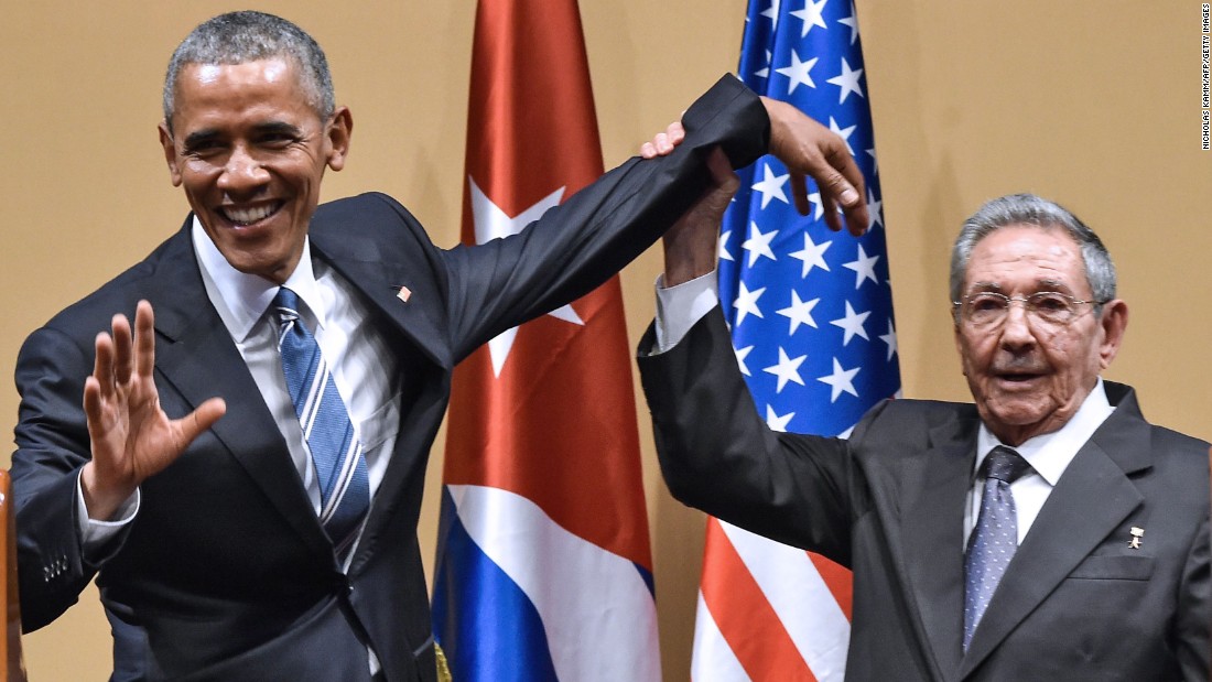 Cuban President Raul Castro tries to lift up Obama&#39;s arm at the end of a joint news conference in Havana, Cuba, in March 2016. Castro hailed Obama&#39;s opposition to a long-standing economic &quot;blockade,&quot; but said it would need to end before ties between the two countries are fully normalized.
