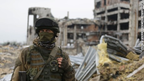 An armed pro-Russian separatist of the self-proclaimed Donetsk People&#39;s Republic (DNR) stands in front of the destroyed Donetsk International Airport, in Donetsk.