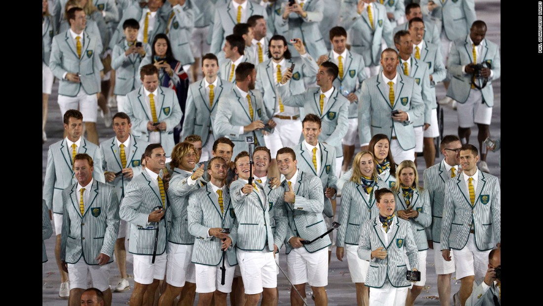 Members of Australia&#39;s Olympic team take photos inside the stadium.