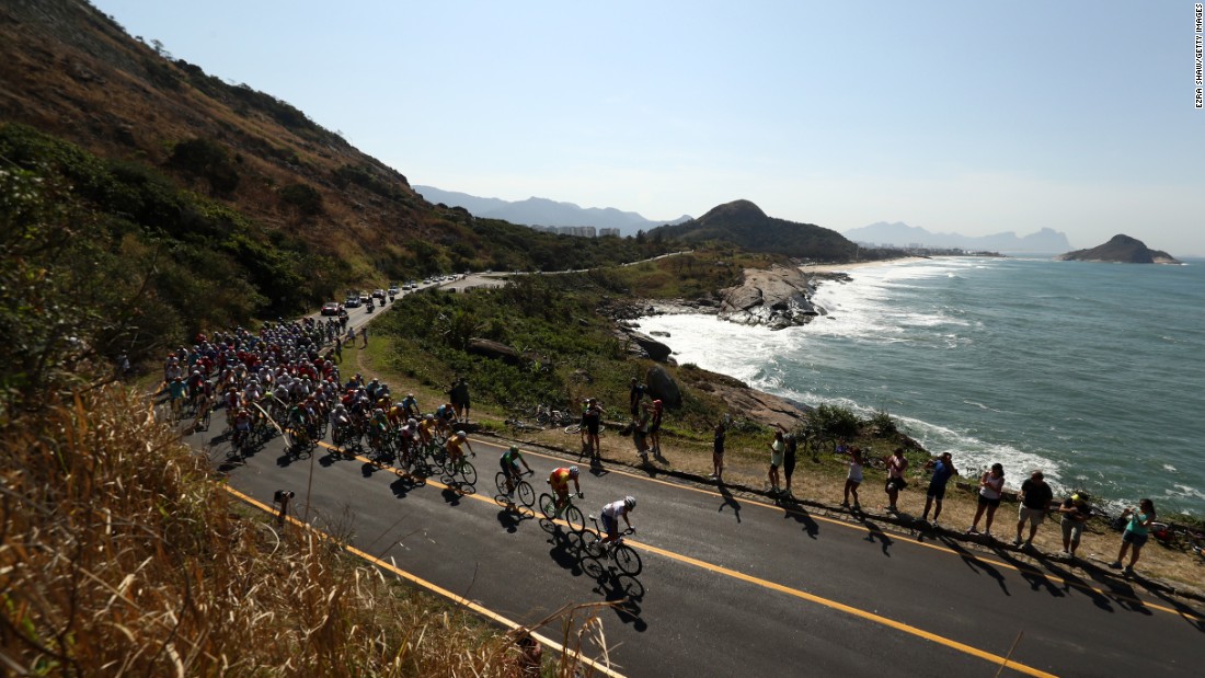The peleton passes through Grumari during the men&#39;s road race in cycling. The race began at Fort Copacabana.