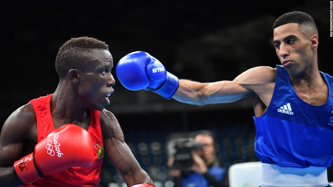 Great Britain&#39;s Galal Yafai, right, punches Cameroon&#39;s Fotsala Simplice during the men&#39;s light fly match.
