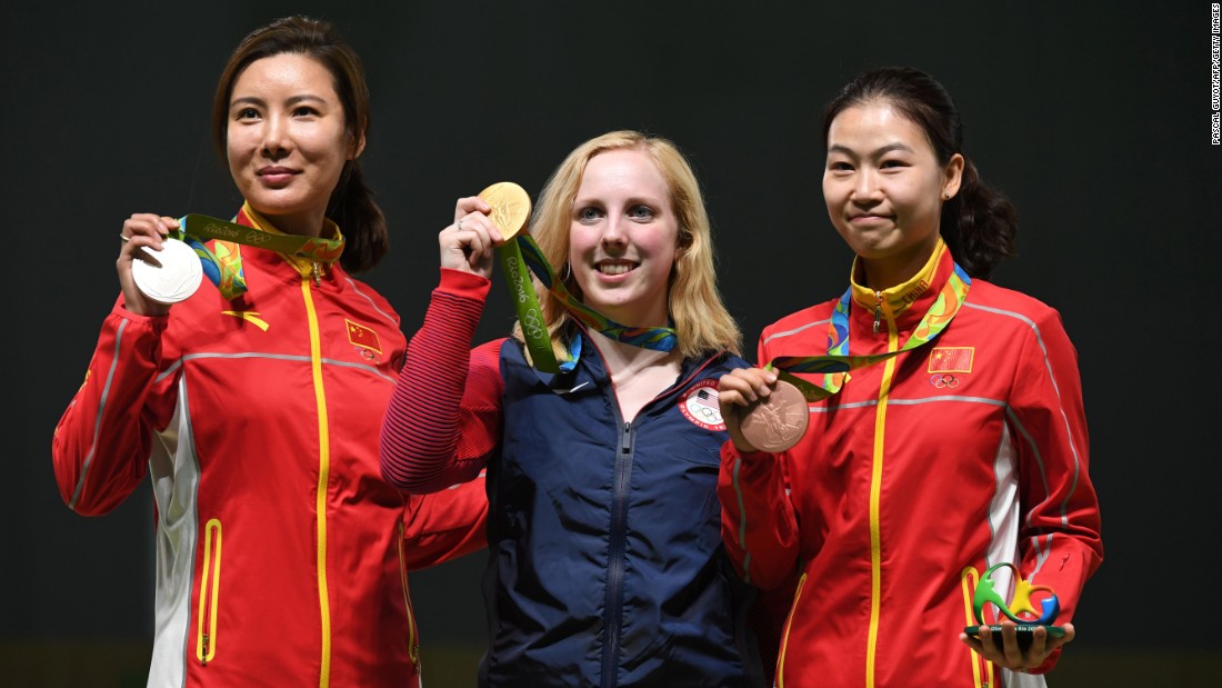 Gold medalist Virginia Thrasher of the U.S., center, poses with China&#39;s silver medal winner Du Li, left, and China&#39;s bronze medalist Yi Siling during the medal ceremony for the women&#39;s 10-meter air rifle shooting event. Thrasher was the first to take home Olympic gold at the Summer Games.