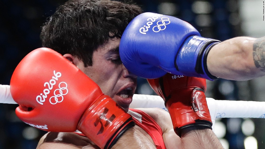Armenia&#39;s Artur Hovhannisyan receives a punch from Spain&#39;s Samuel Carmona Heredia during a men&#39;s light flyweight 49-kg preliminary boxing match. Hovhannisyan lost the match 0-3.