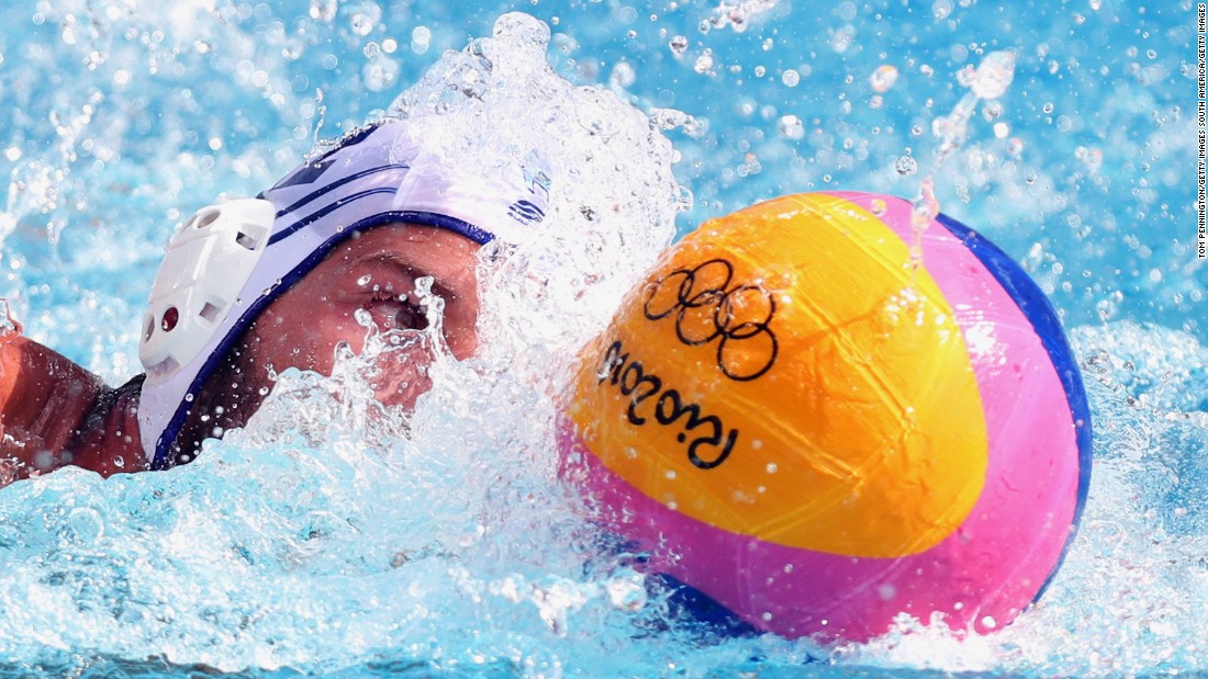 Angelos Vlachopoulos of Greece controls the ball against Japan during the men&#39;s water polo preliminary round group A match.