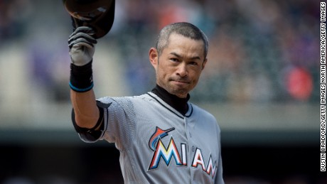 Ichiro Suzuki of the Miami Marlins tips his hat to the crowd after hitting a seventh inning triple against the Colorado Rockies for the 3,000th hit of his MLB career.