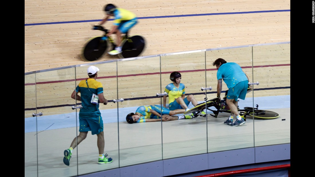 Australian cyclist Melissa Hoskins, center left, lies on the track after the pursuit team crashed during a training session. She was taken to the hospital.