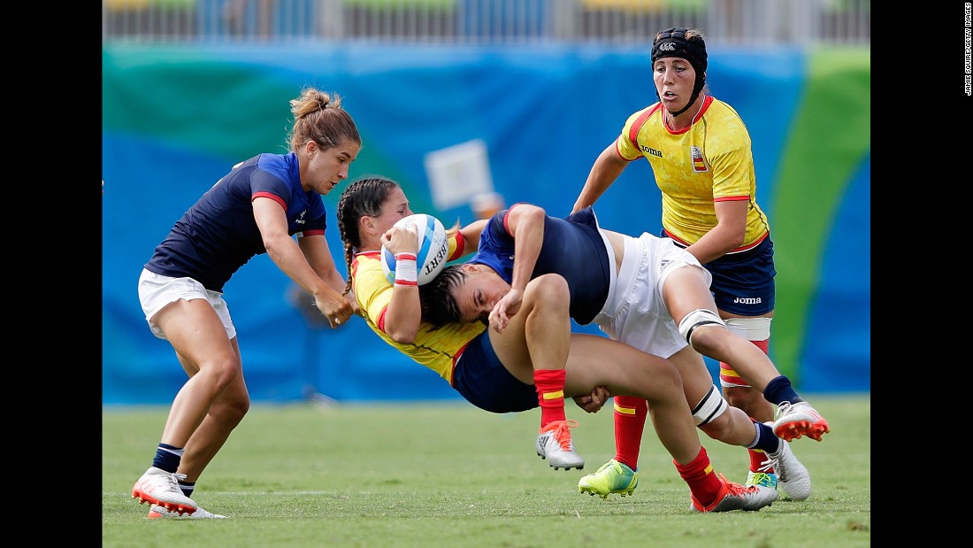 Amaia Erbina of Spain is tackled by Audrey Amiel and Pauline Biscarat of France during a rugby sevens match.