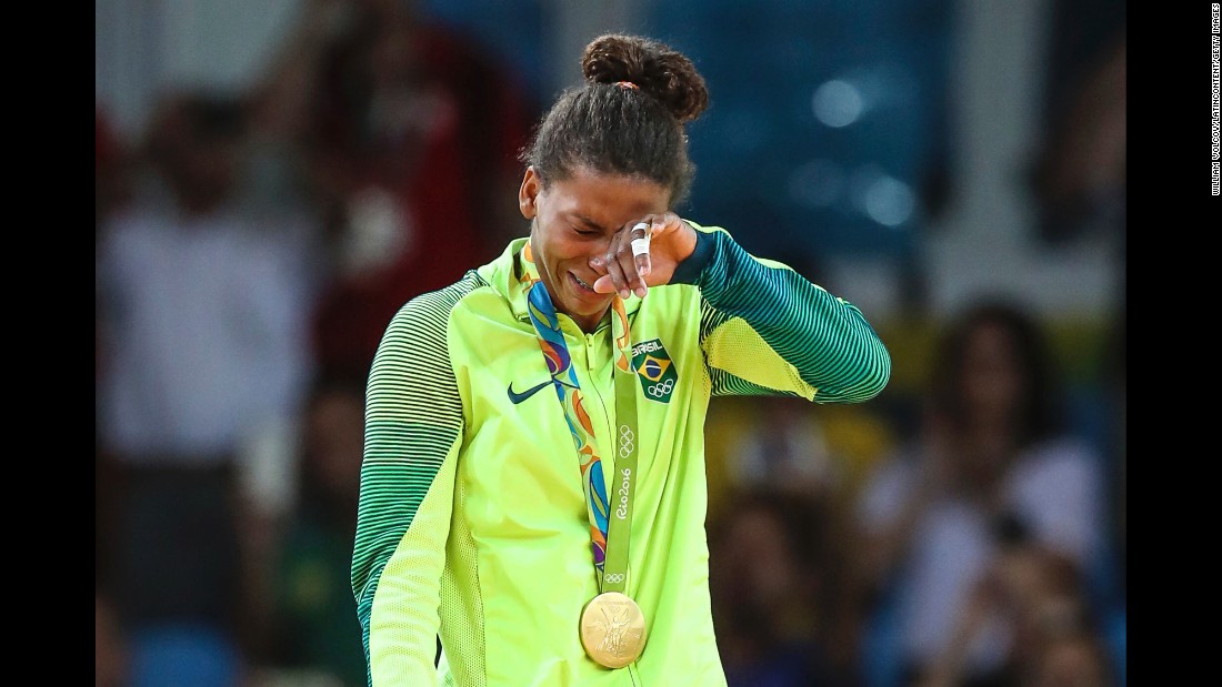 Judoka Rafaela Silva cries on the medal stand after she won Brazil&#39;s first gold at the Rio Games. She defeated Dorjsurengiin Sumiyaa in the final of the 57-kilogram weight class.