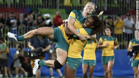 Australia&#39;s Ellia Green lifts up a teammate as they celebrate a gold medal win.