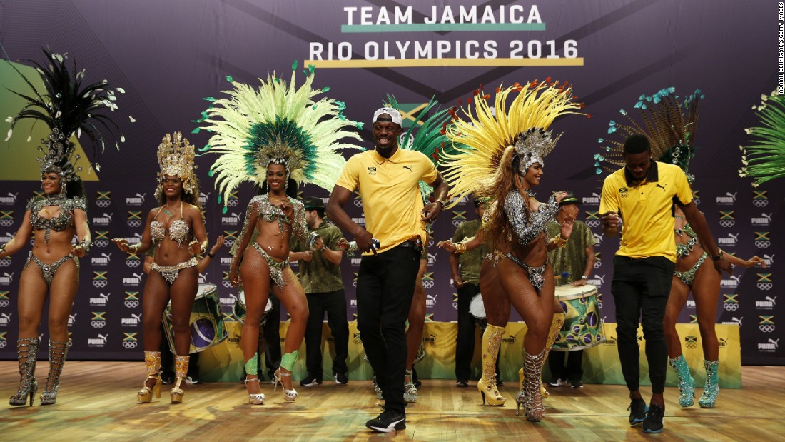 Sprinter Usain Bolt, center, dances the samba during a news conference for Puma and the Jamaican Olympic Association. The world&#39;s fastest man will be defending his 100-meter title later in the Games.