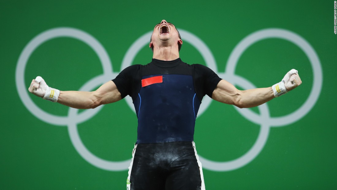 Moldovan weightlifter Serghei Cechir celebrates after finishing in first place in the 69-kilogram (152-pound) weight class. He lifted 144 kilograms (317.5 pounds) in the snatch and 178 kilograms (392.4 pounds) in the clean and jerk for a combined 322 kilograms (709.9 pounds).