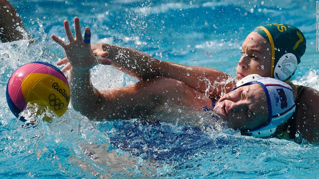 Australia&#39;s Rowie Webster, right, mugs Russia&#39;s Anna Timofeeva during a water polo match.