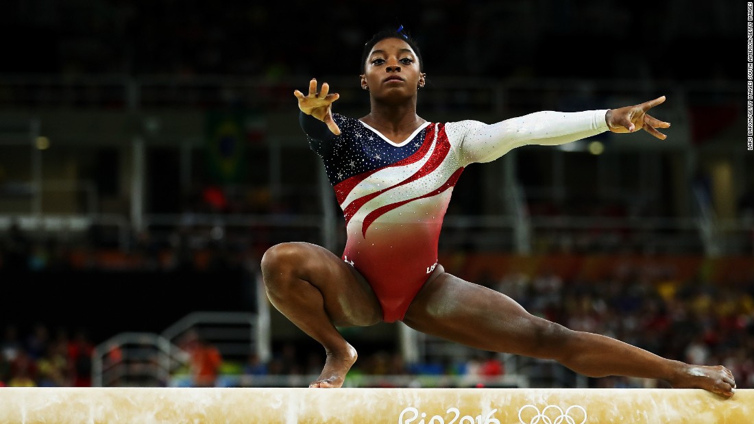 Remember that the balance beam in gymnastics is only 4 inches wide. Near the start of Biles&#39; balance beam performance she does an extremely difficult element called the Wolf Turn. Squatting on her right foot, with her arms and left leg outstretched -- she spins two-and-a-half times around. Then, without falling, Biles stands upright to continue her routine. 