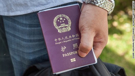 A Chinese national holds a Chinese passport on May 16, 2014.
