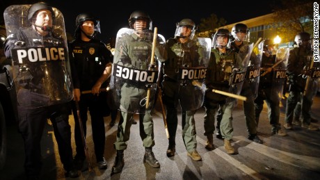 FILE - In this April 29, 2015 file photo, police stand in formation as a curfew approaches in Baltimore. In the wake of the Freddie Gray case, the police union has push back against reforms designed to provide citizens with more oversight, the union also has sued to block a civilian review board from having access to police disciplinary records. 