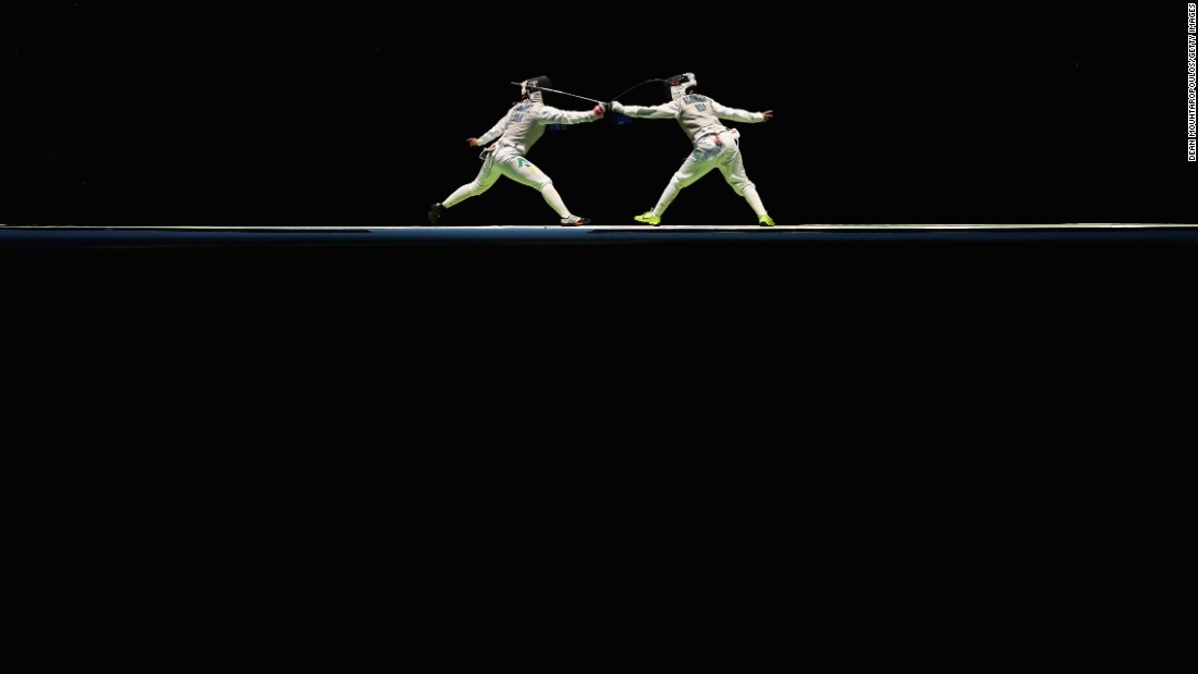 Brazilian fencer Tais Rochel, left, faces off against Saudi Arabia&#39;s Lubna Al-Omair during the women&#39;s individual foil competition.