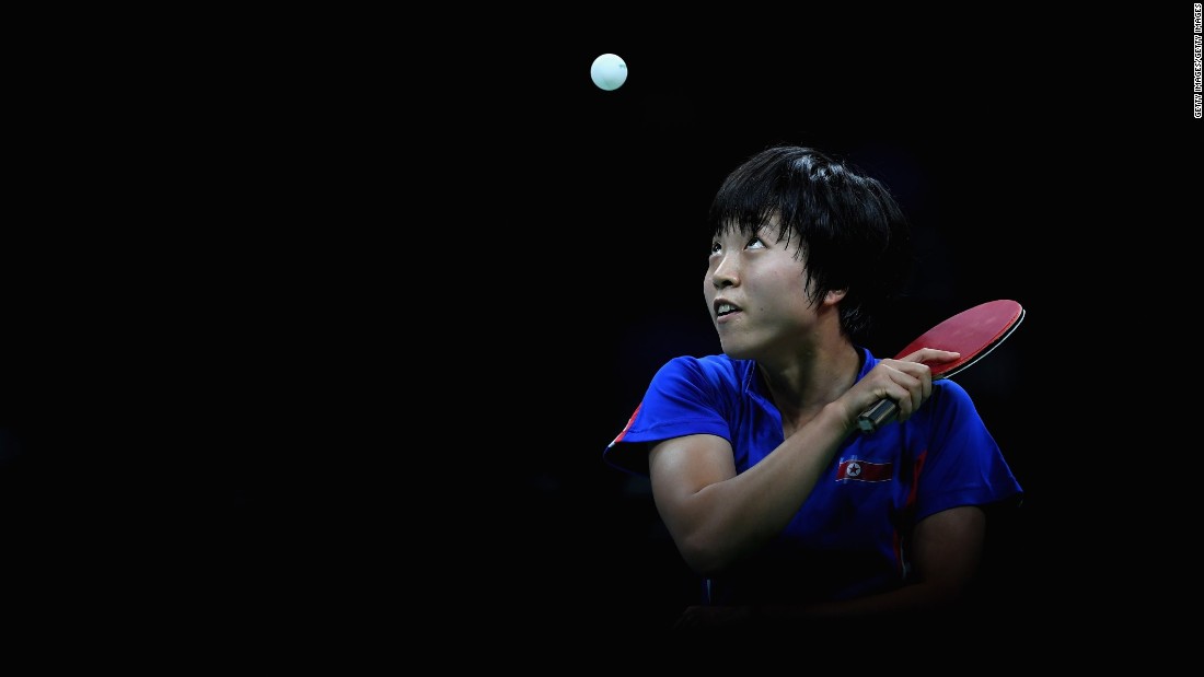 North Korean table tennis player Kim Song-i focuses on the ball during her semifinal match against Ding Ning of China. Ding advanced to the gold-medal match, which she won.