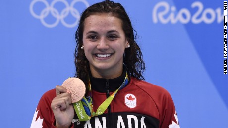 Canada&#39;s Kylie Masse poses with her bronze medal following the 100 meter backstroke event.