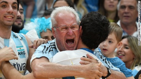  Argentinian volleyballer Demian Gonzalez is hugged by a fan after his team won the men&#39;s qualifying volleyball match between Russia and Argentina at the Maracanazinho stadium in Rio de Janeiro.
