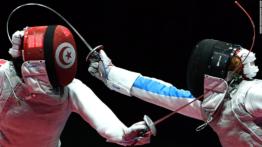 Tunisian fencer Ines Boubakri, left, competes against Italy&#39;s Elisa Di Francisca during a semifinal bout in the individual foil competition. Di Francisca advanced to the final but lost to Russia&#39;s Inna Deriglazova.