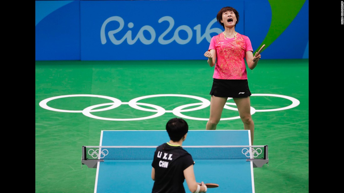 China&#39;s Ding Ning, top, reacts after defeating her compatriot Li Xiaoxia to win table tennis gold.