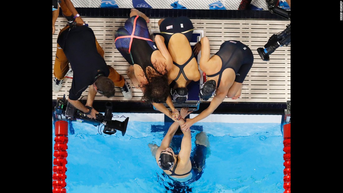 Katie Ledecky is congratulated by her U.S. teammates Allison Schmitt, Leah Smith and Emily DiRado after swimming the anchor leg of the 4x200 freestyle on Wednesday, August 10. The gold medal is Ledecky&#39;s third of the Rio Games.