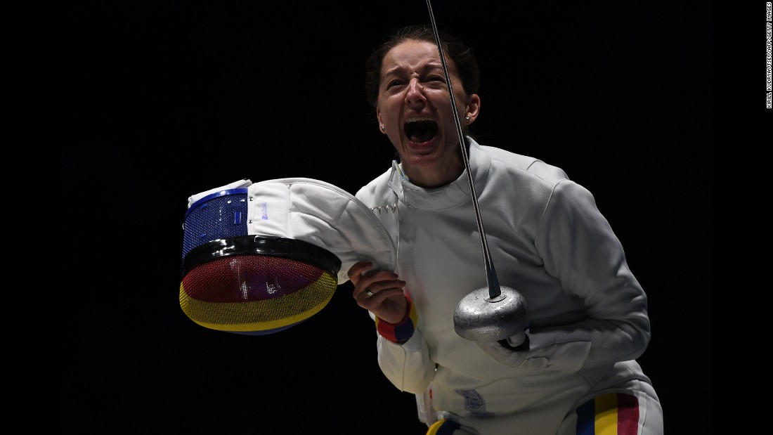 Romania&#39;s Ana Maria Popescu celebrates after her fencing team won an epee quarterfinal match against the United States.