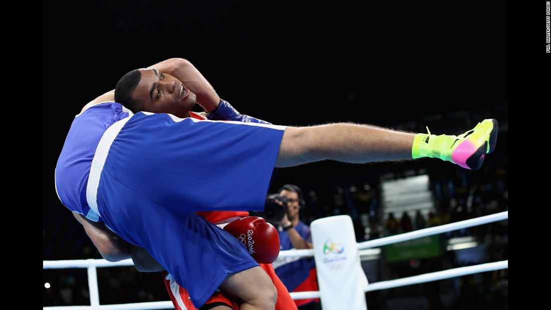 Venezuelan boxer Albert Ramirez, in red, faces Algeria&#39;s Abdelhafid Benchabla in a light-heavyweight bout. Benchabla advanced to the quarterfinals.