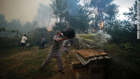 Residents work to fight a wildfire in As Neves in northwestern Spain on Thursday.