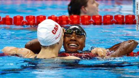 American Simone Manuel embraces Penny Oleksiak of Canada after the pair tied to win gold in the Women&#39;s 100m freestyle final on Day 6 of the Rio 2016 Olympic Games this August.