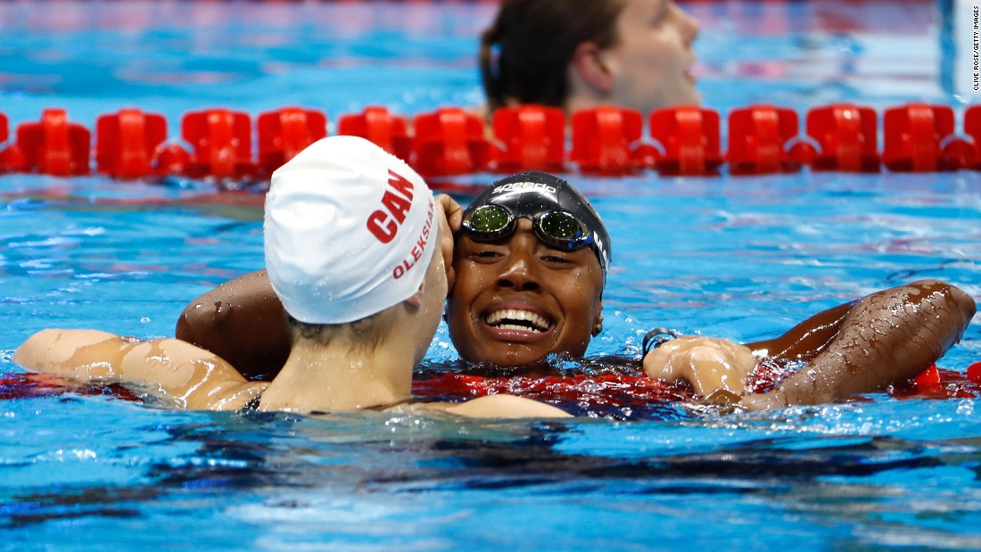 U.S. swimmer Simone Manuel, right, hugs Canadian Penny Oleksiak after they tied for first place in the 100-meter freestyle. They finished in an Olympic-record time of 52.70 seconds. Manuel is the first African-American woman to medal in an individual swimming event.