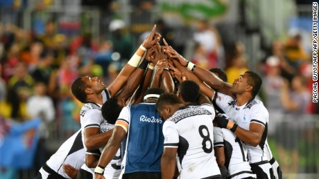 Fiji&#39;s players pray after victory in the men&#39;s rugby sevens gold medal match.