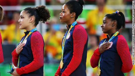RIO DE JANEIRO, BRAZIL - AUGUST 09:  (R to L) Gold Medalists Simone Biles, Gabrielle Douglas, Lauren Hernandez, Madison Kocian and Alexandra Raisman of the United States stand on the podium for the national anthem at the medal ceremony for the Artistic Gymnastics Women&#39;s Team Final on Day 4 of the Rio 2016 Olympic Games at the Rio Olympic Arena on August 9, 2016 in Rio de Janeiro, Brazil.  (Photo by Alex Livesey/Getty Images)